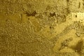 Old weathered cracked peeling airbrushed golden graffiti paint. Gold background with rough texture. Royalty Free Stock Photo