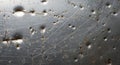A metal surface with a weathered appearance, featuring numerous scratches, dents, Royalty Free Stock Photo