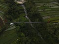 Metal suspension bridge built over a ravine with a river