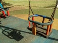 Two empty swings in park on fall morning