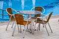 Metal  and chairs with wicker seats in outdoor cafe Royalty Free Stock Photo