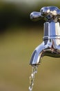 Metal tap with drain water outdoors Royalty Free Stock Photo