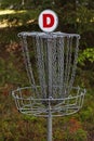 a metal target for frisbee golf in the forest Royalty Free Stock Photo