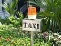 Metal Taxi stand sign with orange rotating light Royalty Free Stock Photo