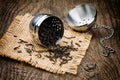 Metal tea infuser on wooden table