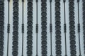 Metal texture of black wrought iron rods with a pattern on a gray fence Royalty Free Stock Photo