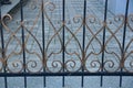 Metal texture from a brown forged pattern on black bars of a fence Royalty Free Stock Photo