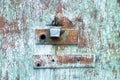 Metal texture with old lock in brown and blue. Silver padlock on old blue door Royalty Free Stock Photo