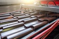 Metal tile for roof in metal forming machine production line close up Royalty Free Stock Photo