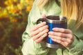 Metal touristic tea cup in Woman hands Outdoor