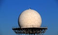 White spherical radar for satellites receiving on a metal structure  over blue sky Royalty Free Stock Photo