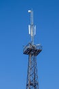 Metal tower with antennas for mobile cell phone communications Royalty Free Stock Photo