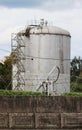 metal tower with flammable fuel in the territory of a fence with barbed wire