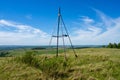 Metal tower on top of a hill. Geodesic, triangulation point.