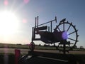 Metal Tractor Sign Driving Off into the Sunset