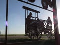 Metal Tractor Sign Silhouetted in the Sunlight