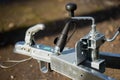 Metal trailer hitch with hand crank and electrical plug representing reliability, utility, and functionality of modern towing and Royalty Free Stock Photo