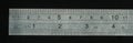 Metal transparent ruler with black background.