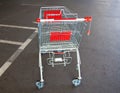 Metal trolley shopping basket at asphalt