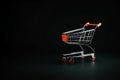 Metal trolley on wheels from a supermarket on a black background