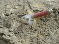 A metal trowel with a red handle sticks out of a dry sand-cement mortar Royalty Free Stock Photo