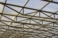 The metal truss structure of the roof is covered with sheets of plastic