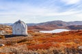 Metal US bunker and autumn greenlandic orange tundra landscape w