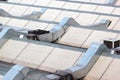 Metal ventilation ducts and tubes on a rooftop. Royalty Free Stock Photo
