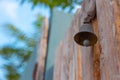 Metal vintage doorbell. Closeup view of a doorbell hanging on the door.