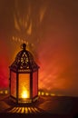 Metal Vintage Lantern background lit by candlelight with deep red and gold colors