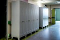 Metal wardrobes in the locker room. Empty school or kindergarten corridor with grey wardrobe lockers. Royalty Free Stock Photo