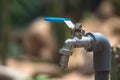 Metal water tap spigot stainless steel faucet lever ball valve blue handle connected to adapter manatee pipe. Blur Royalty Free Stock Photo