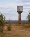 Metal water tower in the field Royalty Free Stock Photo