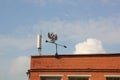 Metal weather vane on the roof of the building Royalty Free Stock Photo