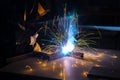 Metal welder working with arc welding machine to weld steel at factory Royalty Free Stock Photo