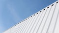 Metal white sheet for industrial building and construction on blue sky background. Roof sheet metal or corrugated roofs Royalty Free Stock Photo