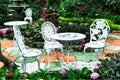 Metal white table and chairs with flowers pattern style in public park background Royalty Free Stock Photo