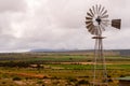Windmill water pump used for crop irrigation. Royalty Free Stock Photo
