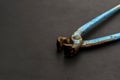 Metal wire cutter, old gripper on a dark gray background. Royalty Free Stock Photo