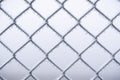 Metal wire fence covered with snow. Cold temperatures. Winter scenery Royalty Free Stock Photo