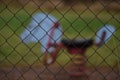 Metal wire mesh fence with an old horse spring rocker behind in a playground Royalty Free Stock Photo