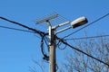 Metal wire mesh stand prepared for stork nest mounted with strong metal pipes on top of concrete utility pole Royalty Free Stock Photo