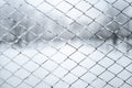 Metal wired fence under a snow - texture background Royalty Free Stock Photo