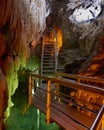 Metal and wood pathway in underground semi submersed cave Royalty Free Stock Photo