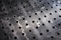Metal workbench with many holes in the factory for welding and working with metal