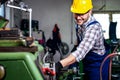 Metal worker turner operating lathe machine at industrial manufacturing factory. Royalty Free Stock Photo