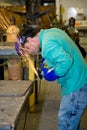 Metal Worker Using Grinder