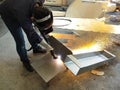 Metal workers use manual labor, The welder is cutting