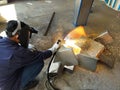 Metal workers use manual labor, The welder is cutting