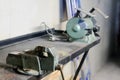 Metal workshop. Vise and bench grinder on metallic workbench